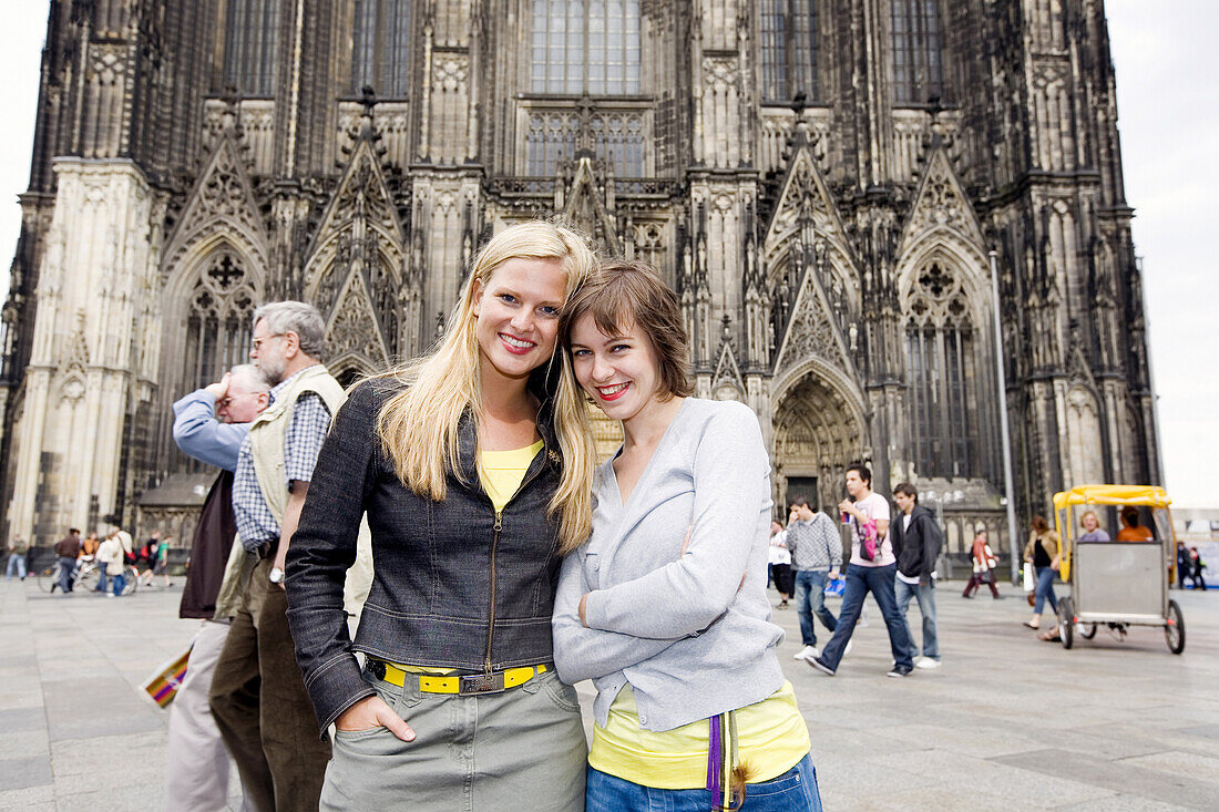 Two young women in front of the Cologne Cathedral, Cologne, North Rhine-Westphalia, Germany