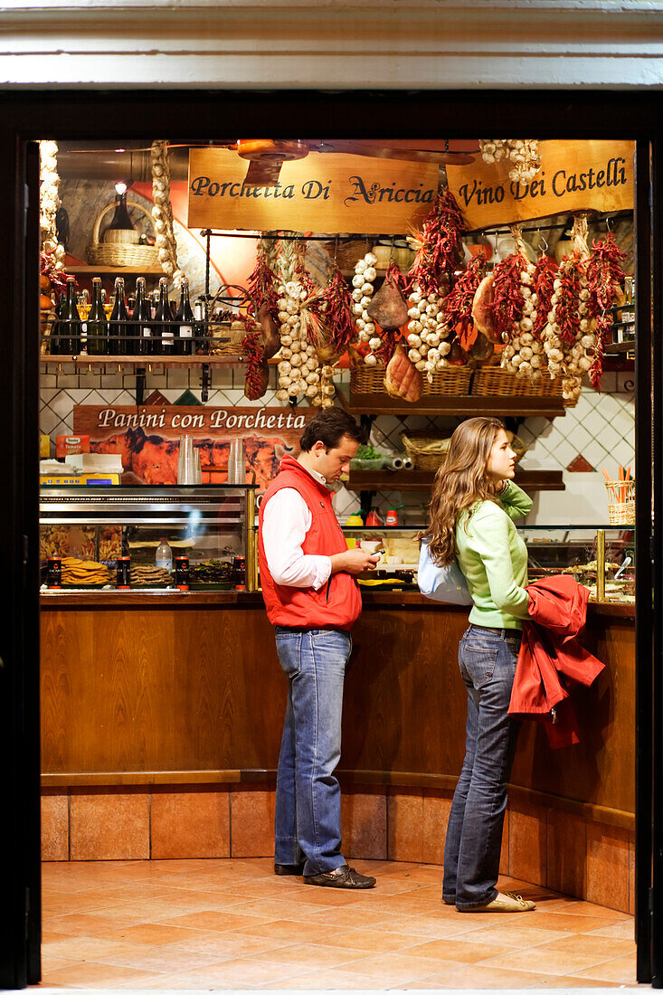 People in a delicatessen store at Campo de Fiori, Rome, Italy