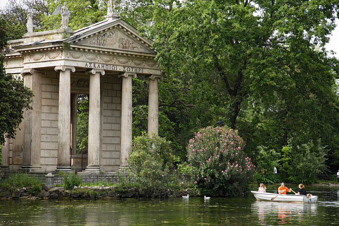 Rowing boats passing Temple of Aesculapius, Villa Borghese Gardens, Rome, Italy