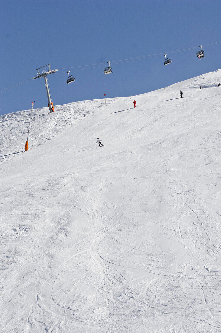 Ski drivers and snow traces under a cablecar, Schnalstal, South Tyrol, Italien