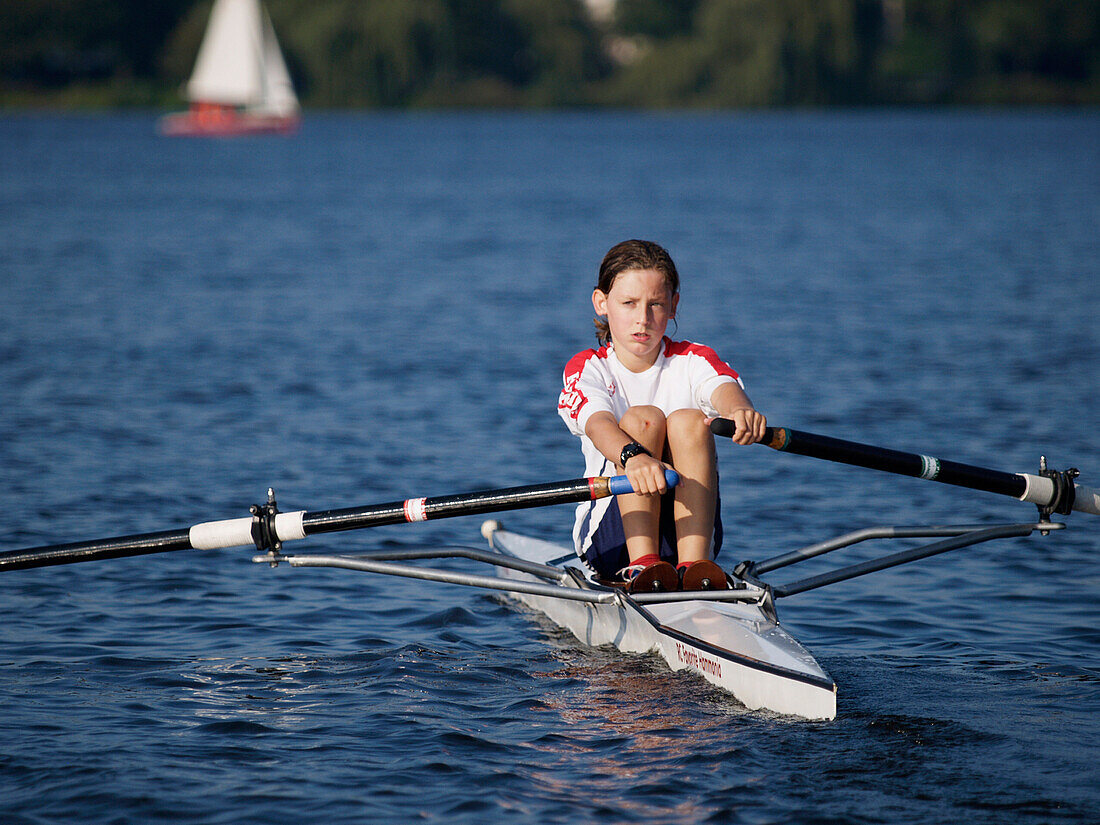 Boy rowing on the Lake Alster, Hamburg, Germany