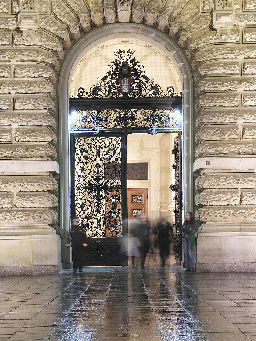 Persons near entrance to town hall, Hamburg, Germany