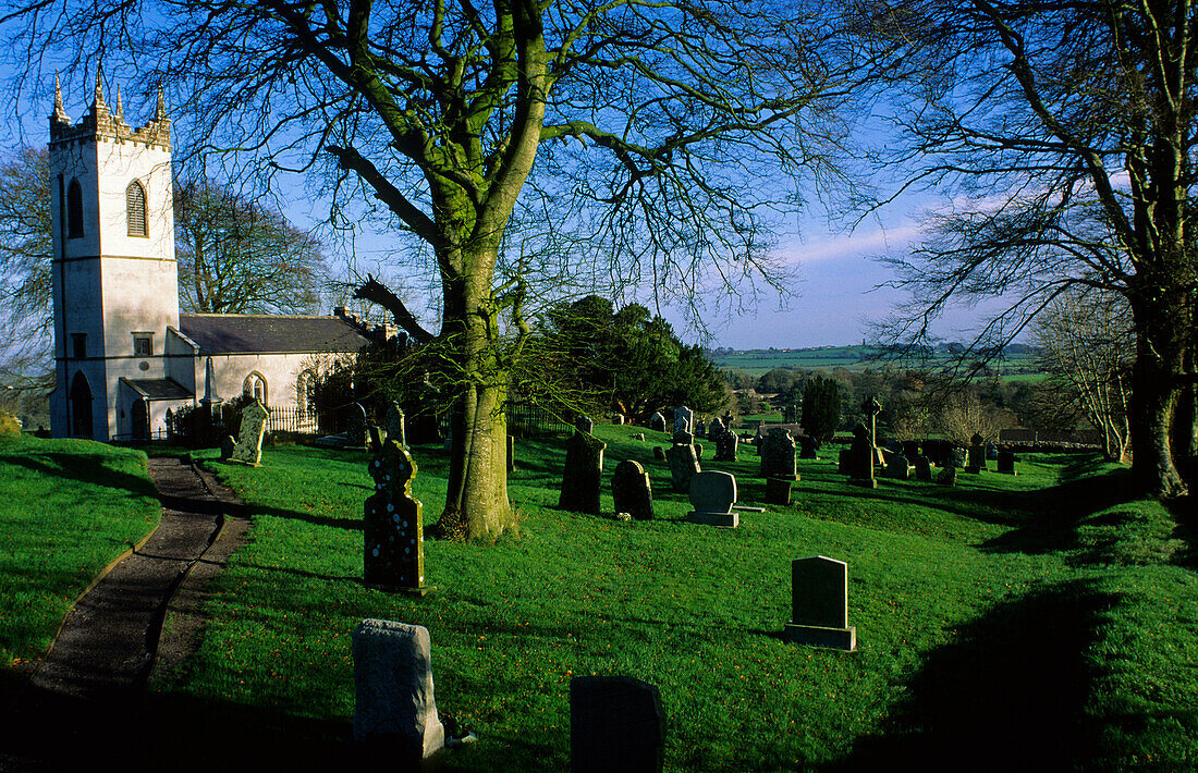 A graveyard in front of a church in the sunlight, Hill of Tara, County Meath, Ireland, Europe