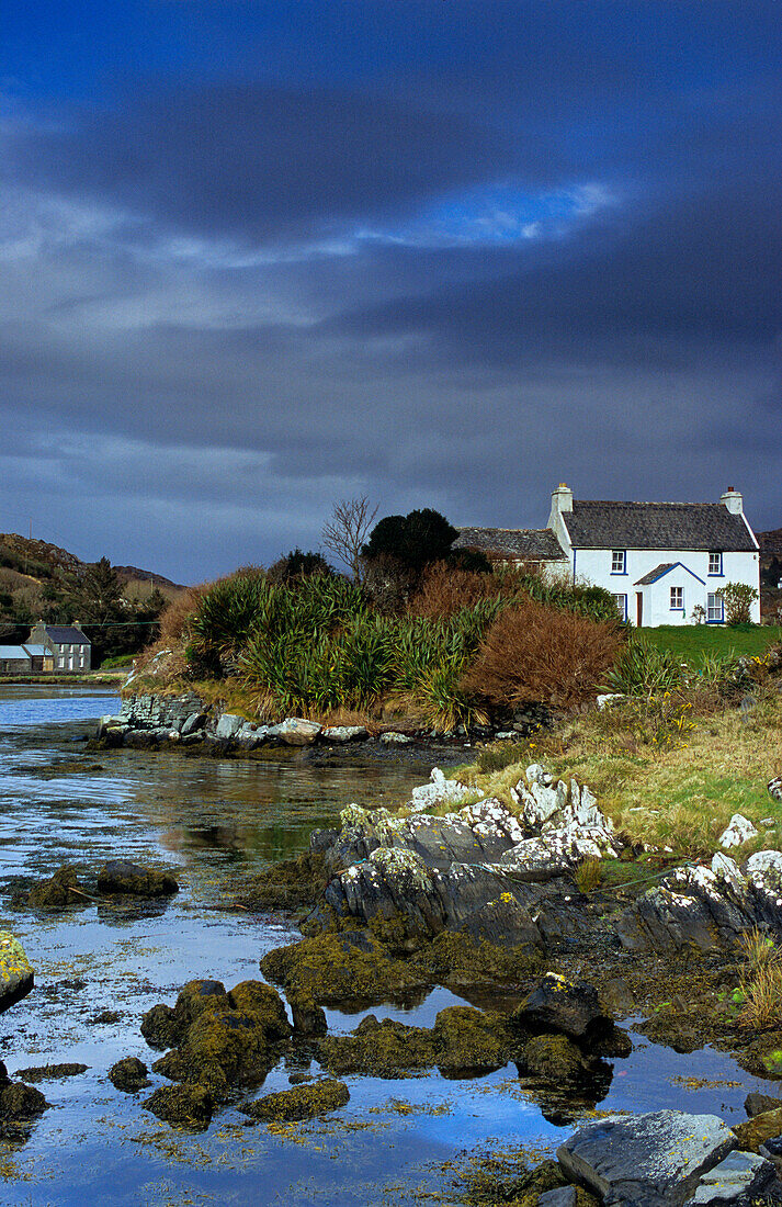 Cottage at Coulagh Bay under rain clouds, County Kerry, Ireland, Europe