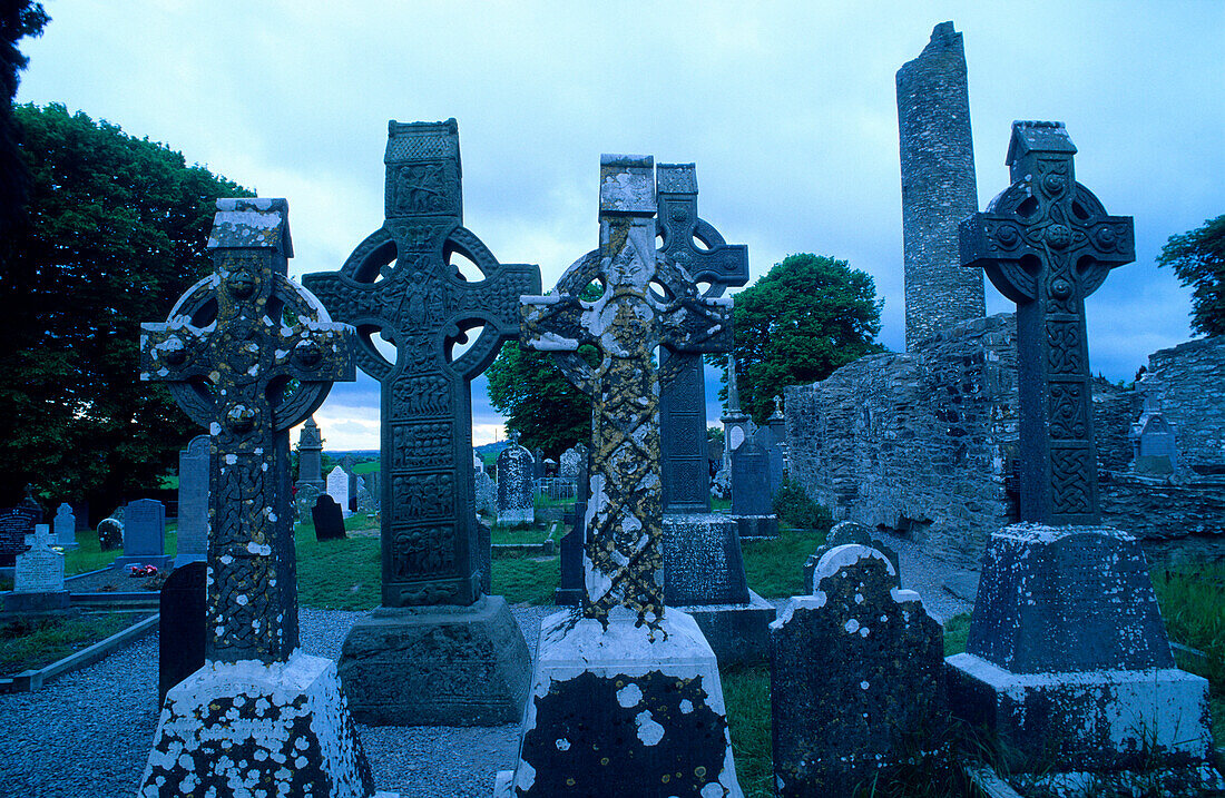 High crosses in front of the ruins of Monasterboice abbey at dusk, County Louth, Ireland, Europe