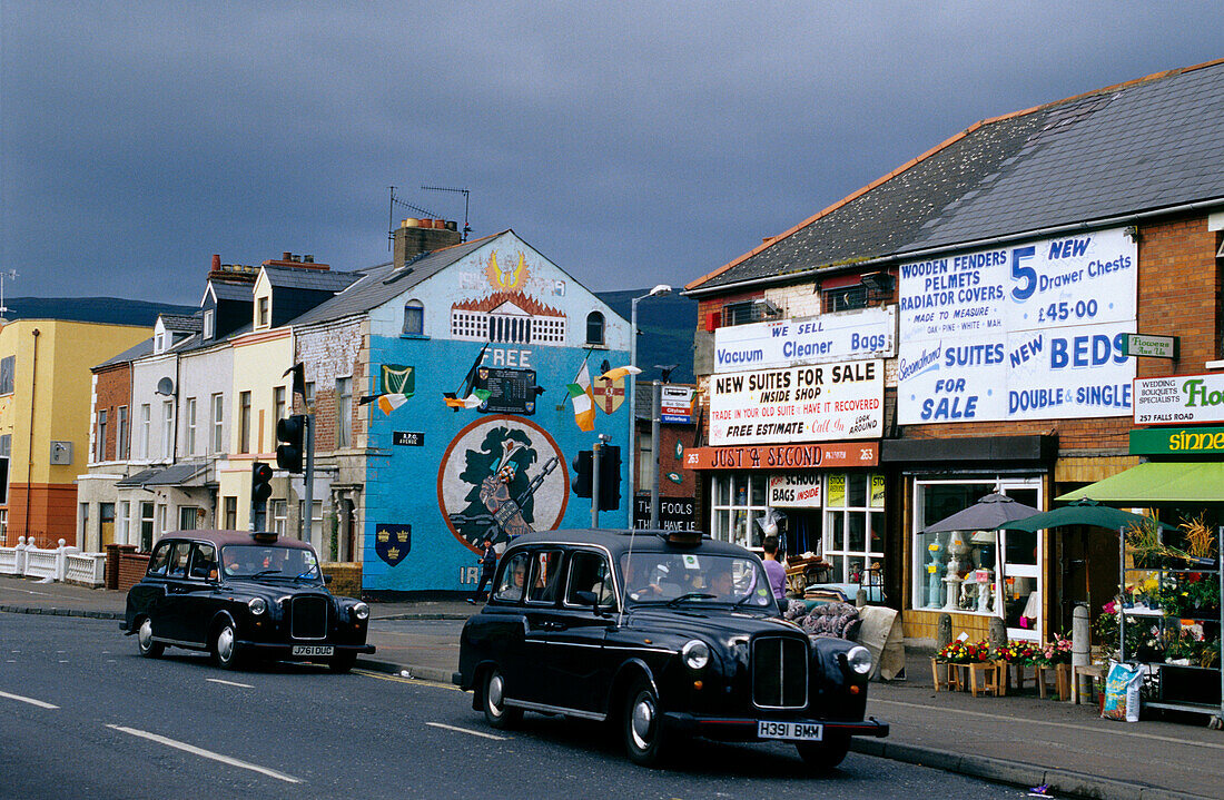 Vintage cars in front of facades of houses at Falls Road, Belfast, County Antrim, Ireland, Europe