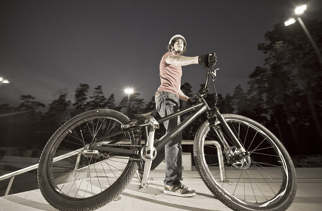 Man trial biking at night, Wagram, Lower Austria, Austria