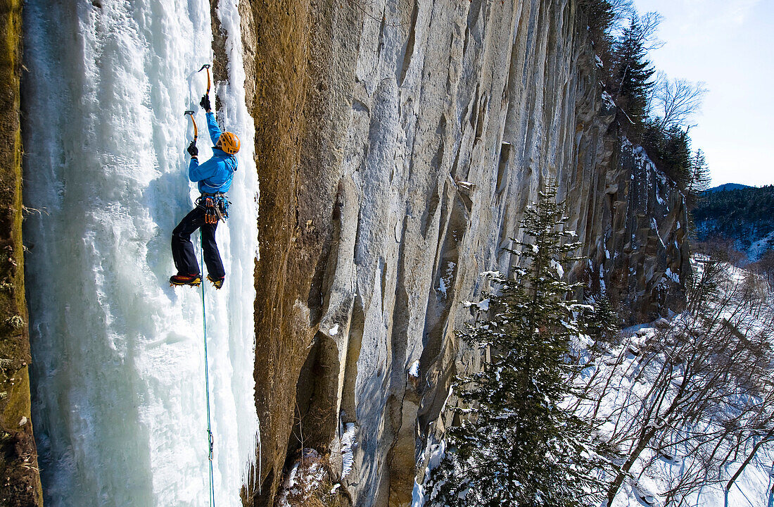 A man climbing up an ice face, Sounkyo, Hokkaido, Japan, Asia