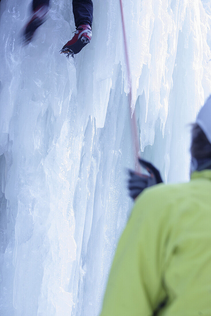 Ice climber on frozen waterfall, Immenstadt, Bavaria, Germany