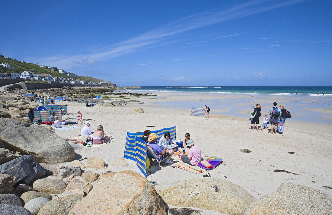 People relaxing at Sennen Cove, Penwith peninsula, Cornwall, England, United Kingdom