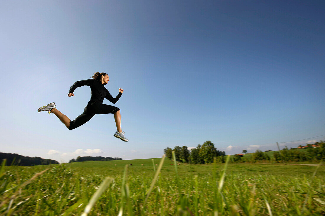 Woman jumping on meadow