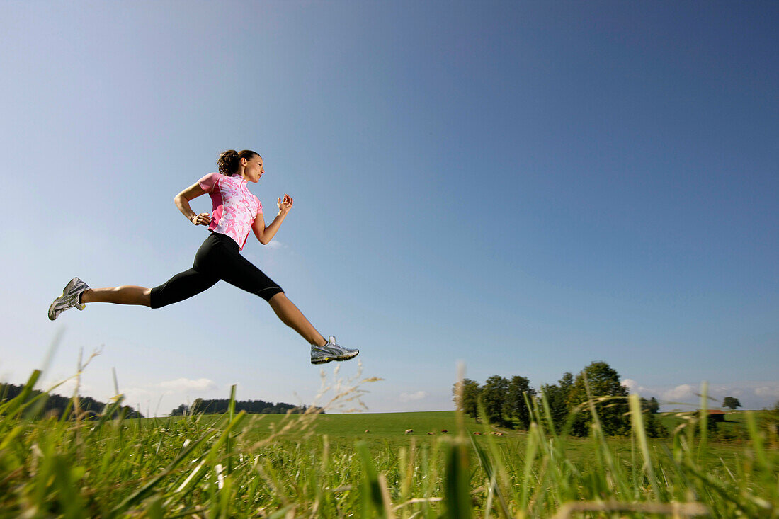 Woman jumping on meadow