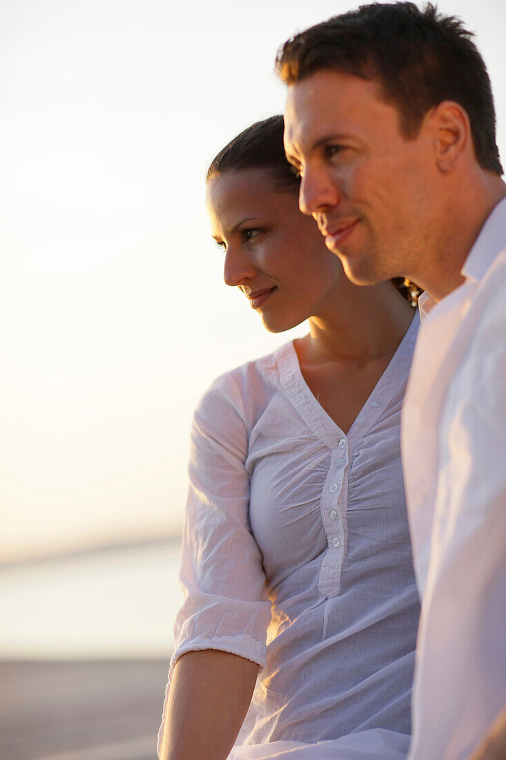 Mid adult couple in sunset, Ambach, Lake Starnberg, Bavaria, Germany