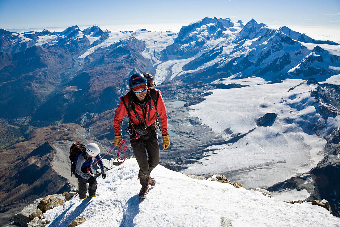 Two mountaineers at mount Matterhorn summit, Canton of Valais, Switzerland