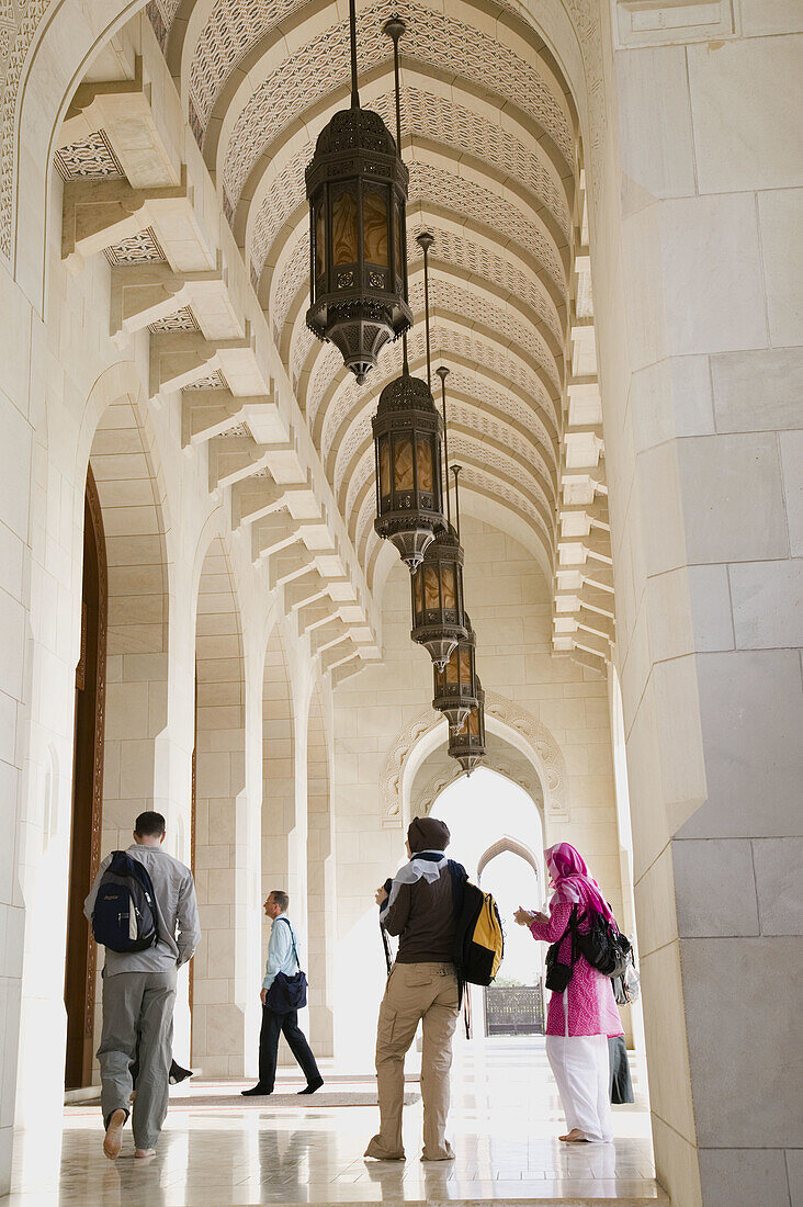 OMAN-Muscat-Al-Ghubrah: Grand Mosque-Arches and Lanterns with Visitors