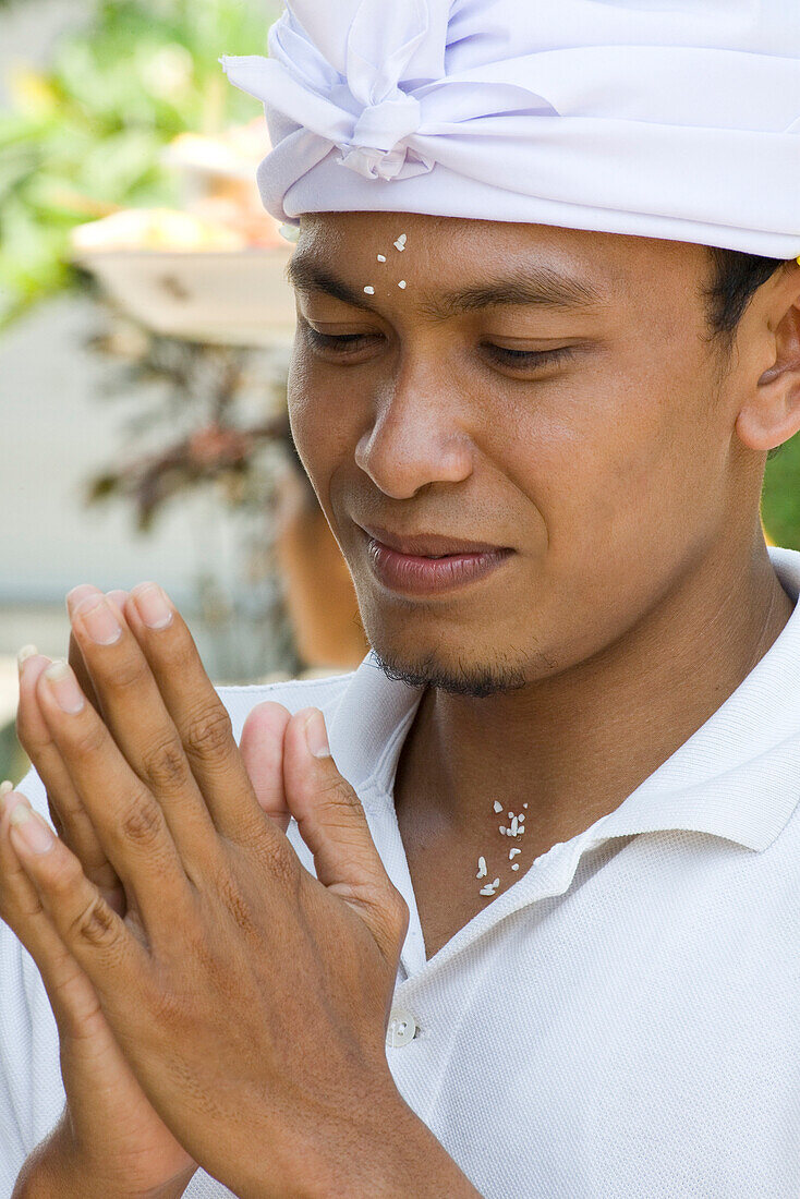 Young balinese man praying, Pejeng, Bali, Indonesia