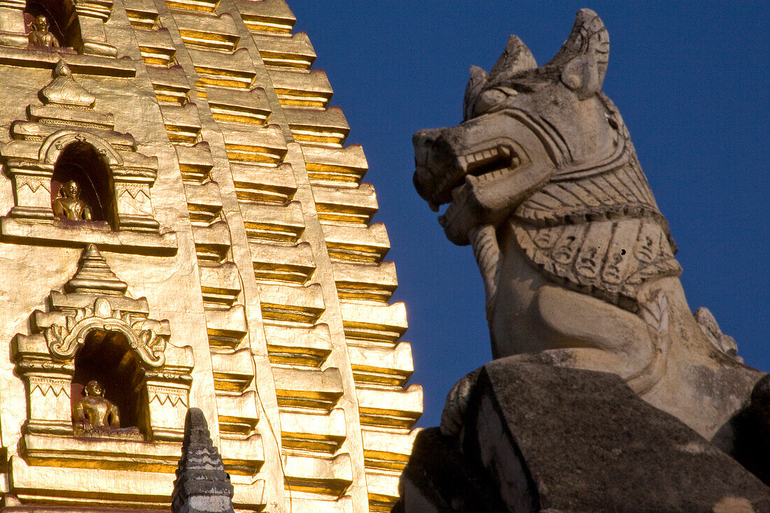 Animal figure in front of a Pagode with golden Stupa in Bagan, Myanmar, Burma