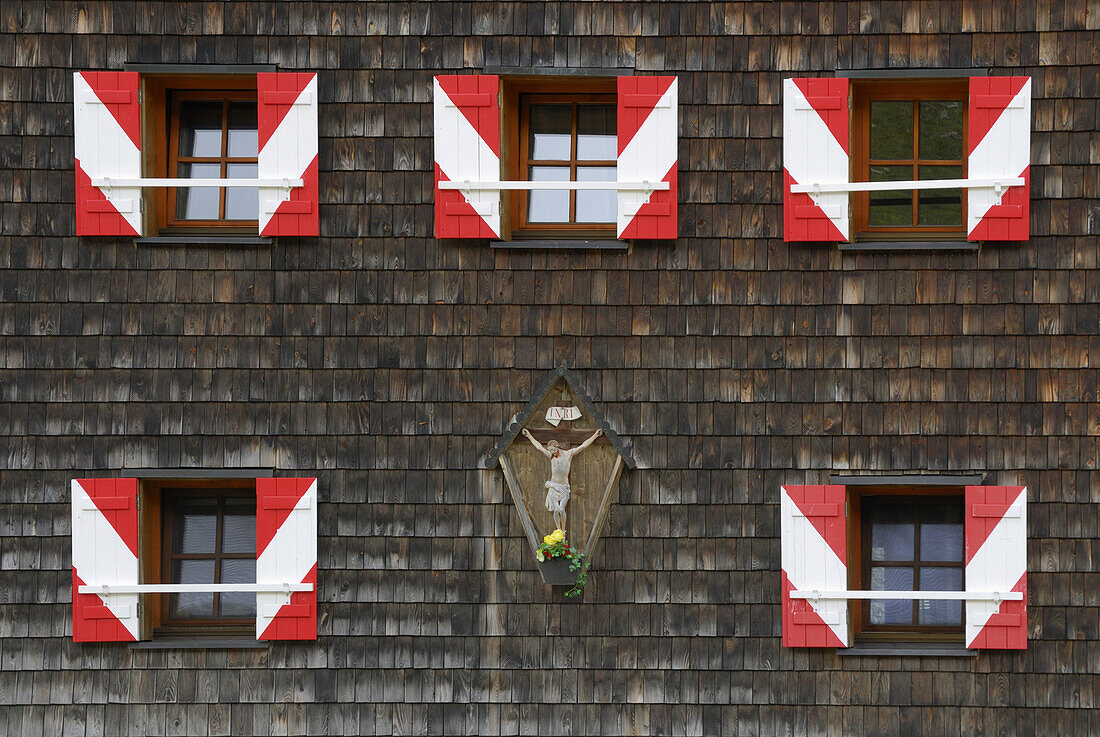 Windows with red and white shutters of an alpine lodge, National Park Hohe Tauern, Tyrol, Austria