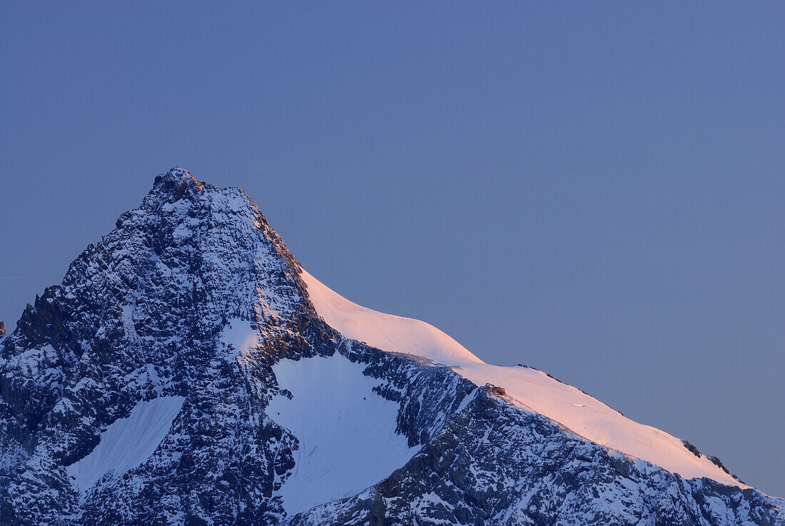 Grossglockner with alpine lodge Adlersruhe in morning light, National Park Hohe Tauern, Tyrol, Austria