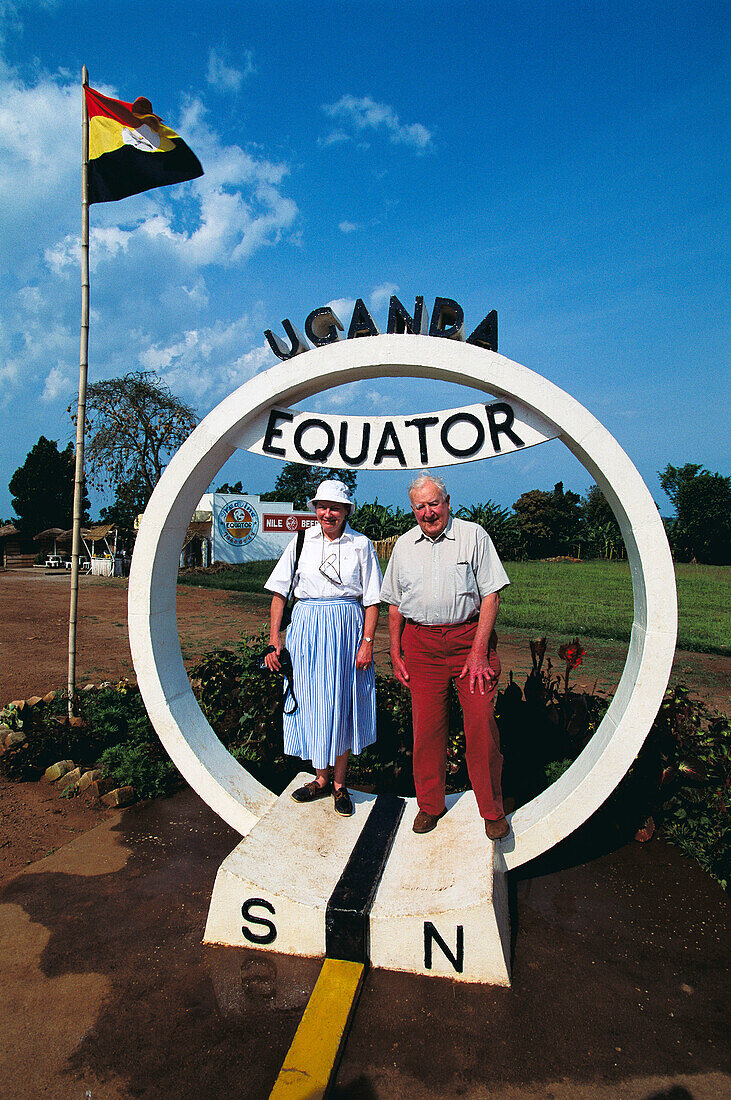 Mature couple at Equator line marker. Uganda