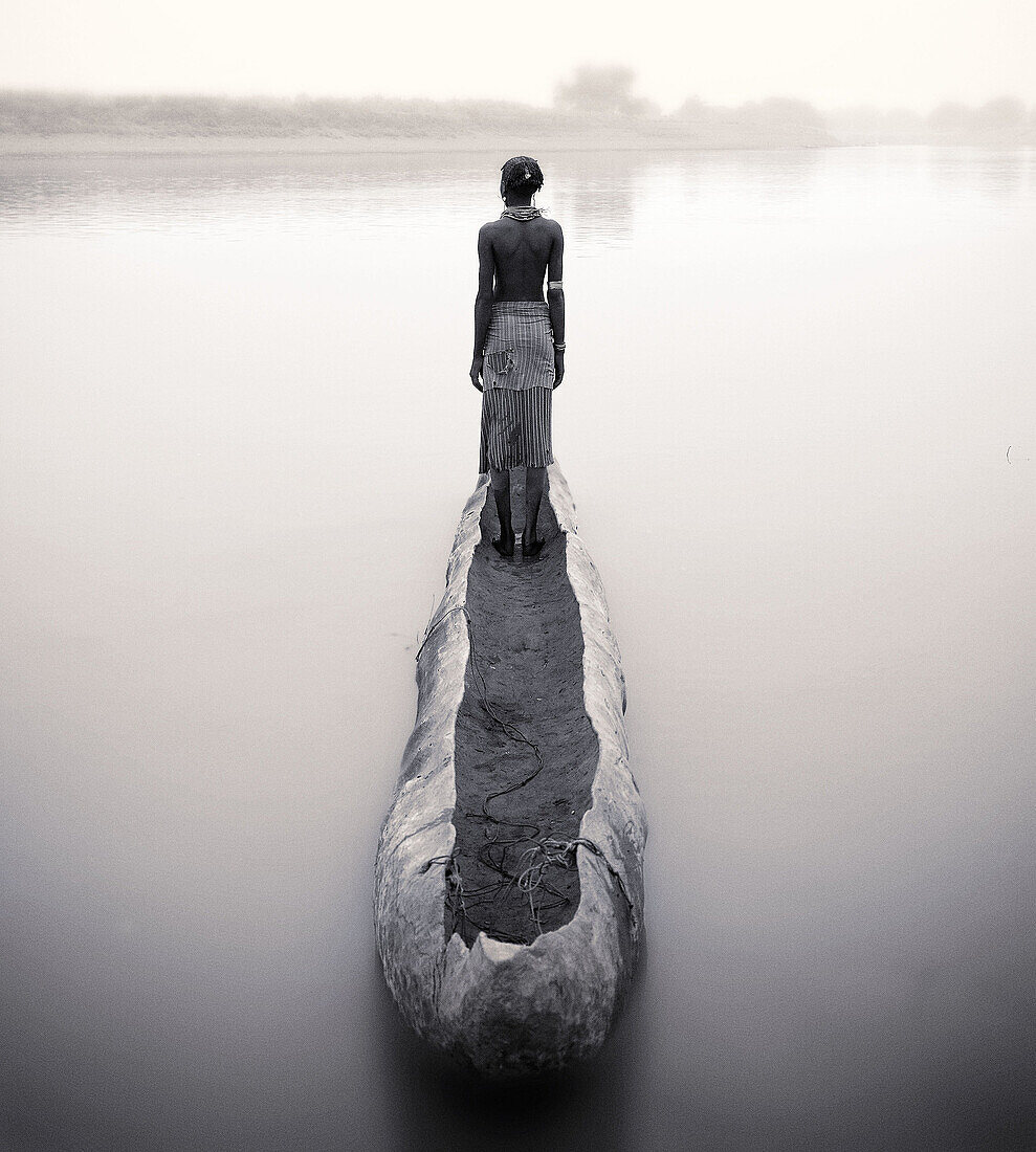 Dasanech woman and boat on Omo River. South Ethiopia