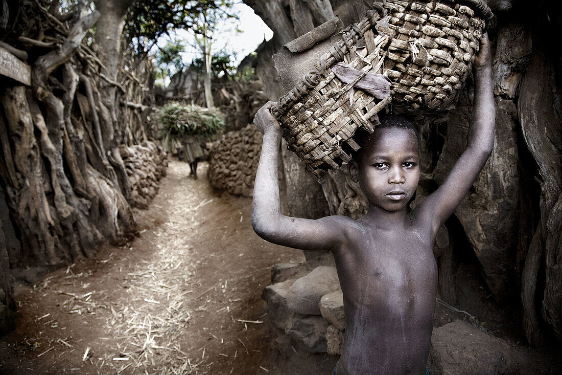 Konso boy carrying basket. South Ethiopia