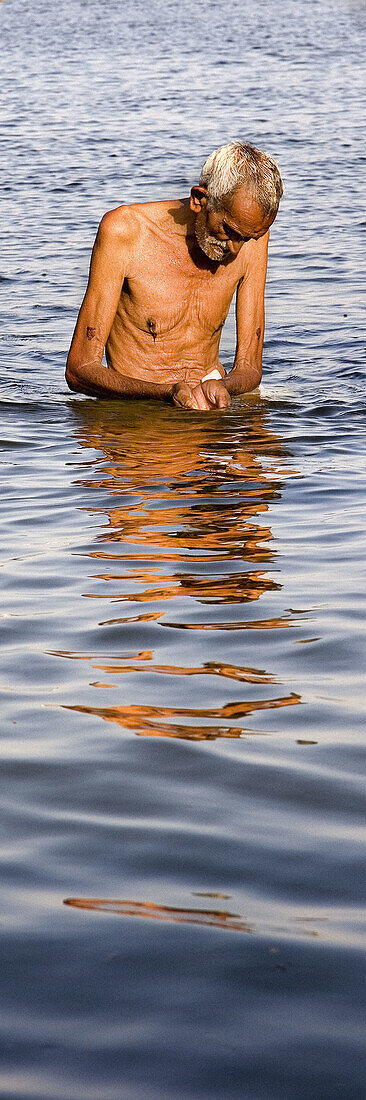 Man praying in the Ganges, Allahabad. Uttar Pradesh, India