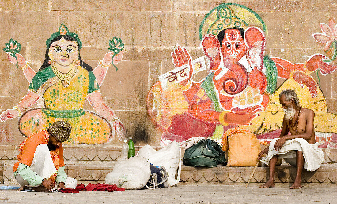 Sadhu and mural paintings, Varanasi. Uttar Pradesh, India