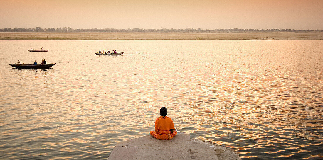 Man meditating in fron of the Ganges, Varanasi. Uttar Pradesh, India