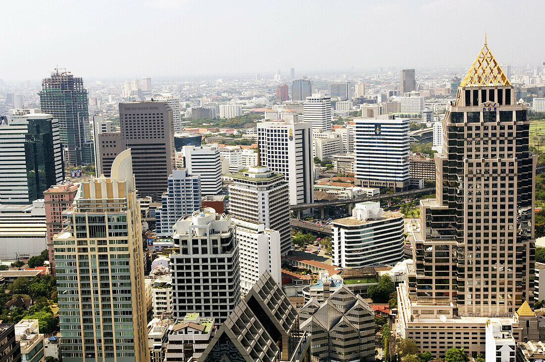 Elevated View of Modern Buildings of Bangrak District and Lumphini Park looking North West, Bangkok. Thailand