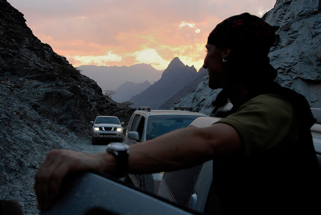Ein Mann und Geländewagen in der Morgendämmerung, Al Hajar Berge, Oman, Asien