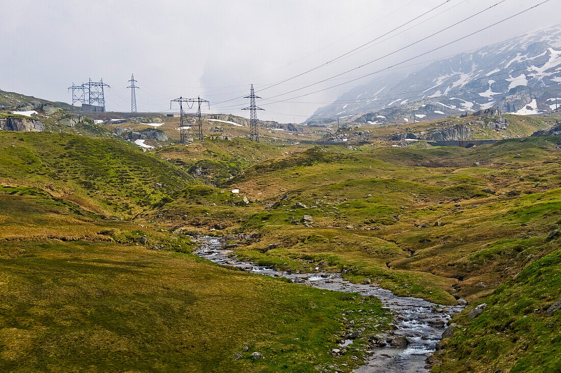 Berglandschaft mit Bach und Hochspannungsleitung, St. Gotthard Pass, Schweiz