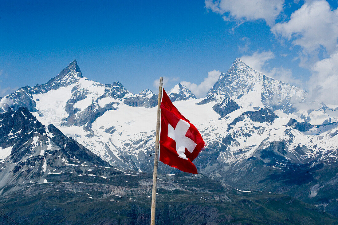 Swiss flag in a mountainous landscape, Valais, Switzerland