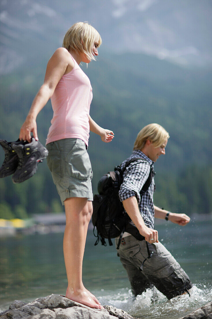 Young couple in lake Eibsee, Werdenfelser Land, Bavaria, Germany