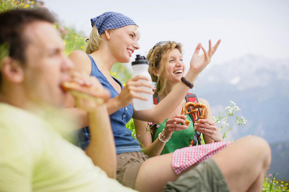 Hikers having a picnic, Werdenfelser Land, Bavaria, Germany