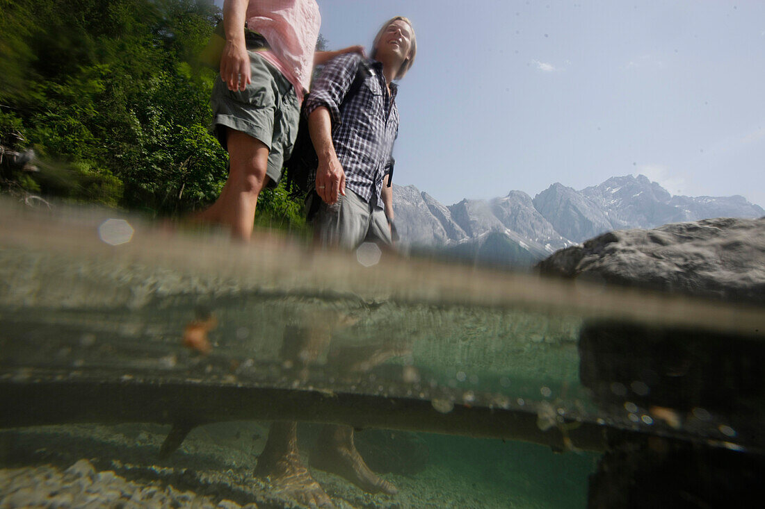 Young couple in lake Eibsee, Werdenfelser Land, Bavaria, Germany