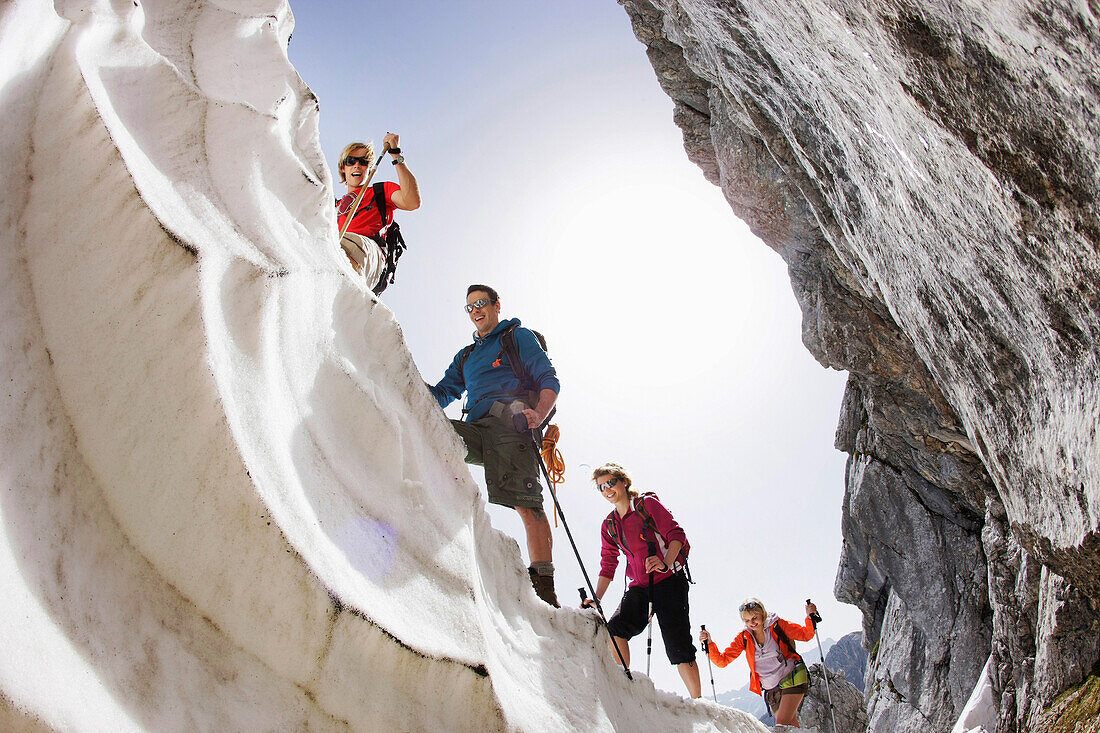 Hikers on cornice, Werdenfelser Land, Bavaria, Germany