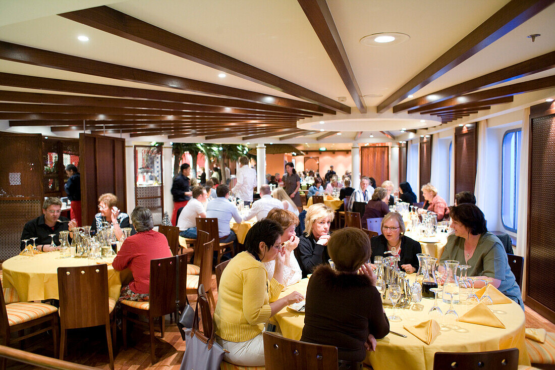 People sitting in the restaurant of cruise ship AidaDiva