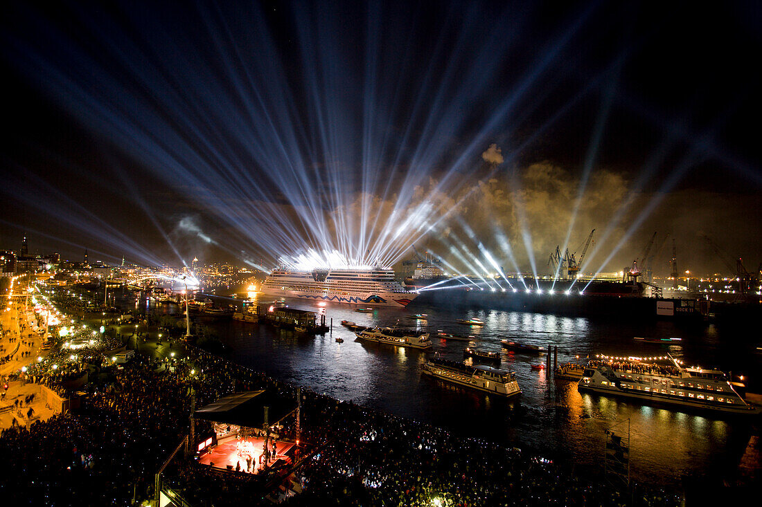 Great lightshow above the ships on the river, Hamburg, Germany