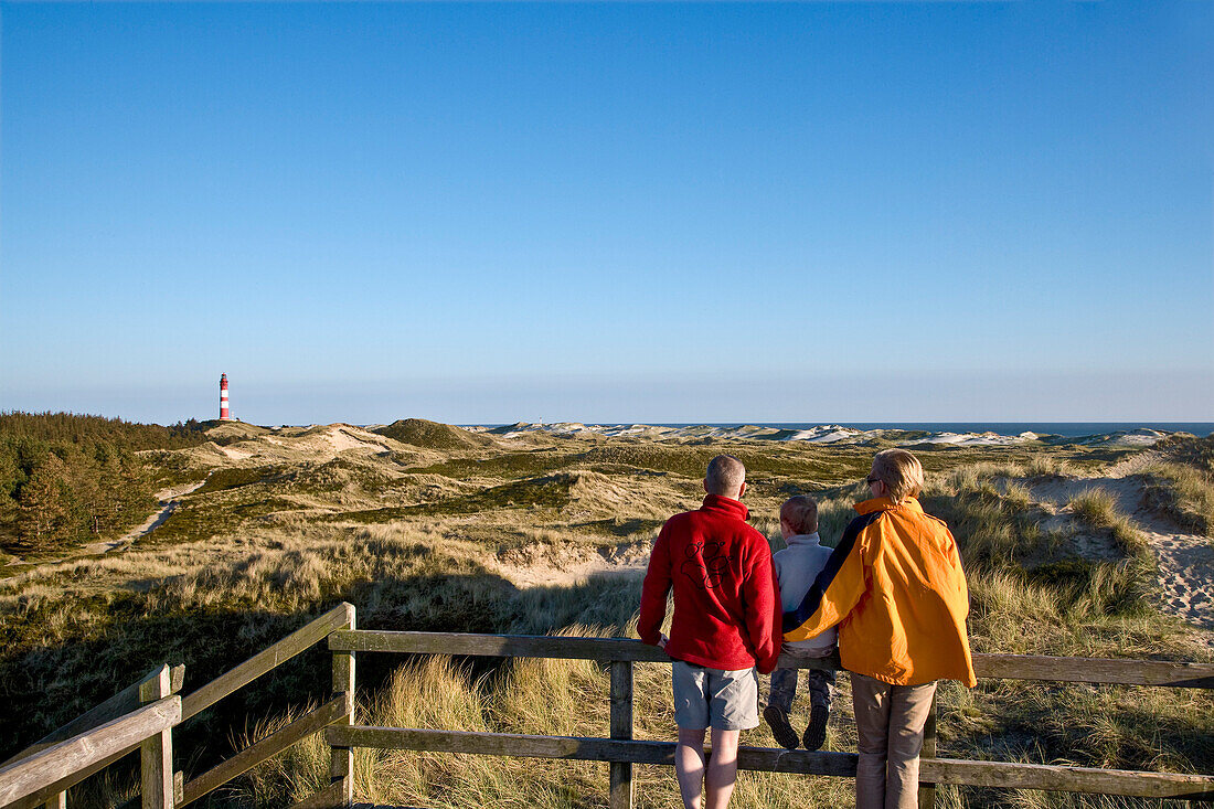 Familiy watching lighthouse, Amrum island, Schleswig-Holstein, Germany