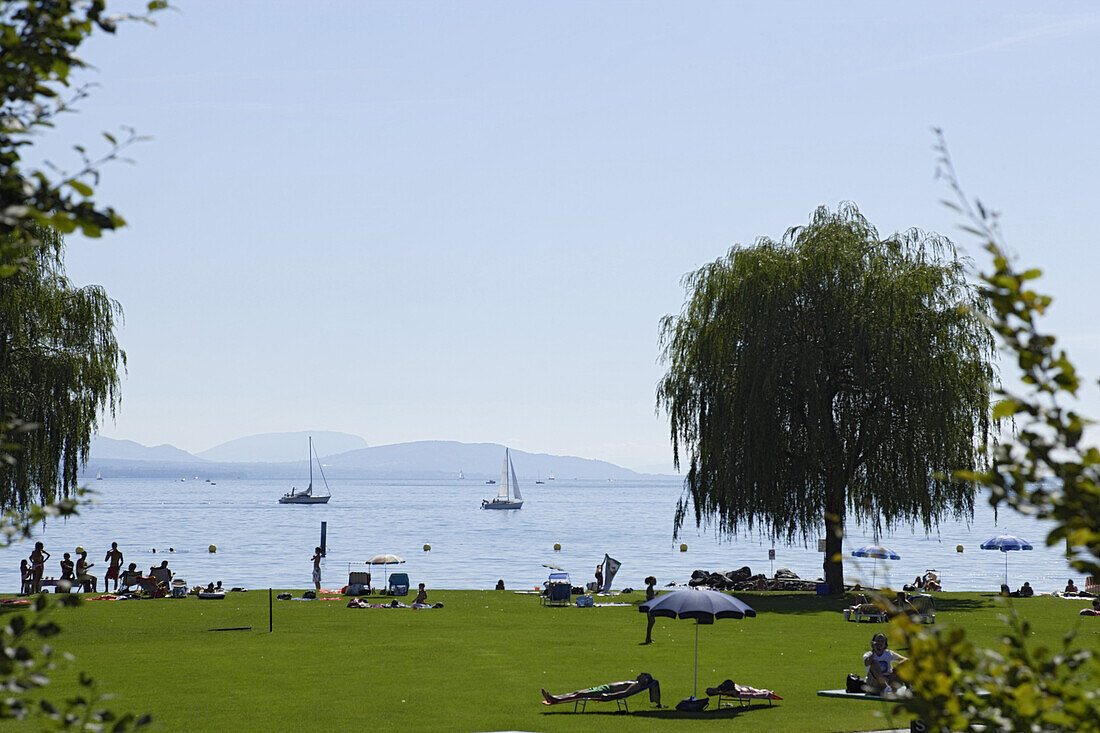 People relaxing at the lake shore of Lake Geneva, Ouchy, Lausanne, Canton of Vaud, Switzerland