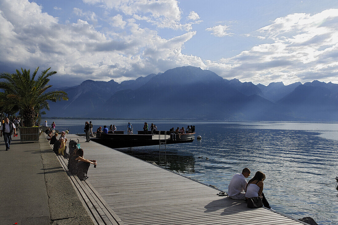 People sitting at promenade at Lake Geneva, Montreux, Canton of Vaud, Switzerland