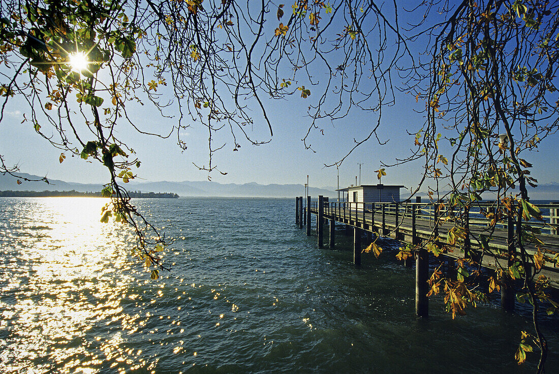 Jetty at the lakeshore in the sunlight, Lake Constance, Bavaria, Germany