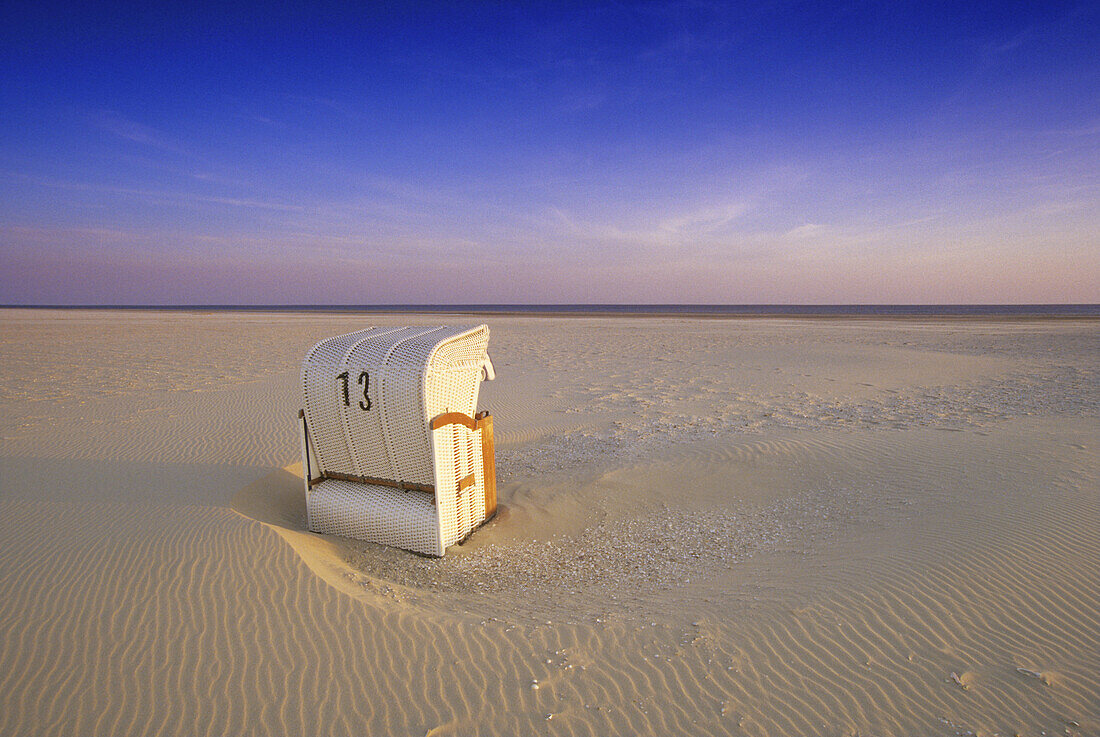 Beach chair at Kniepsand beach in the evening sun, Amrum island, North Friesland, North Sea, Schleswig-Holstein, Germany