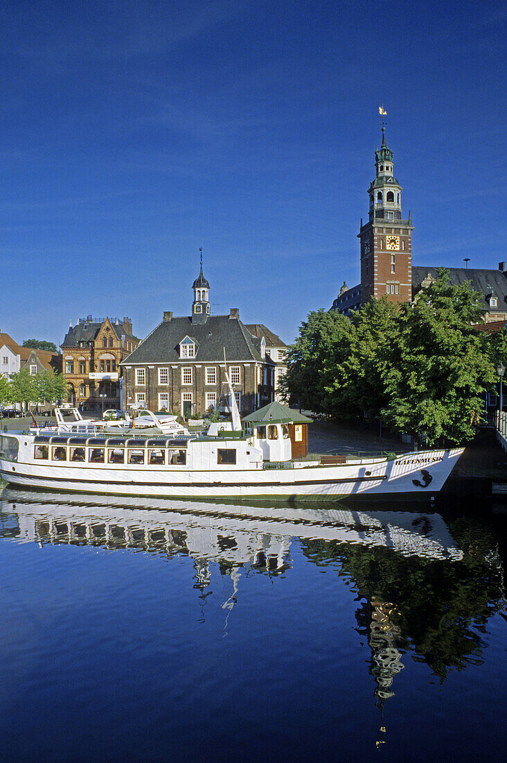 Excursion boat passing town hall and historic building Waage, Leer, Lower Saxony, Germany