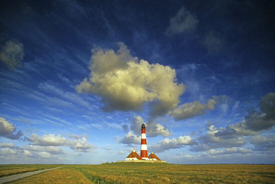 Westerhever lighthouse under cloudy sky, Eiderstedt peninsula, North Friesland, North Sea, Schleswig-Holstein, Germany