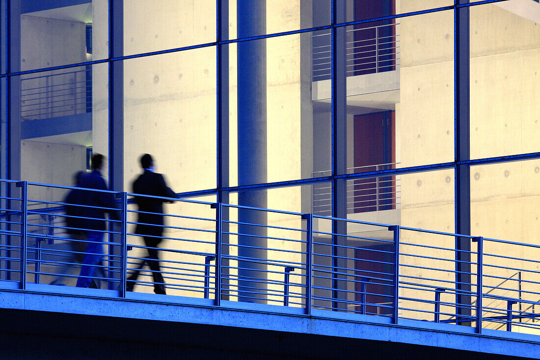 Business people passing pedestrian bridge, Berlin, Germany