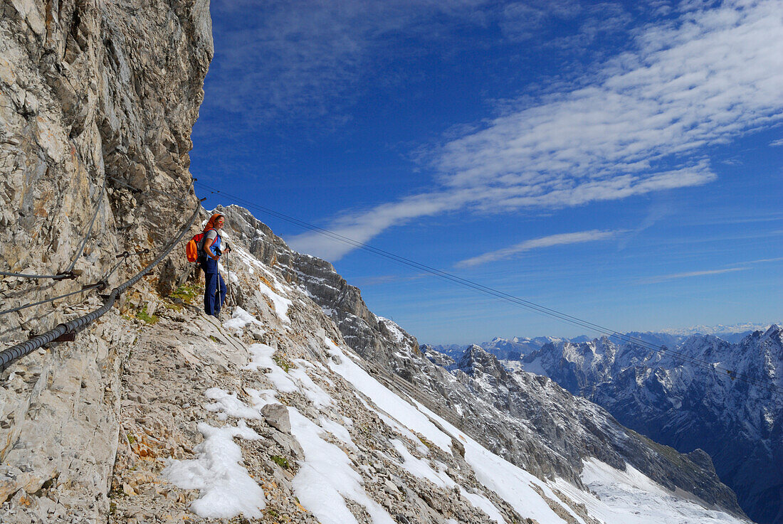 Woman on fixed rope route from Zugspitzplatt to Zugspitze, Wetterstein range, Upper Bavaria, Bavaria, Germany