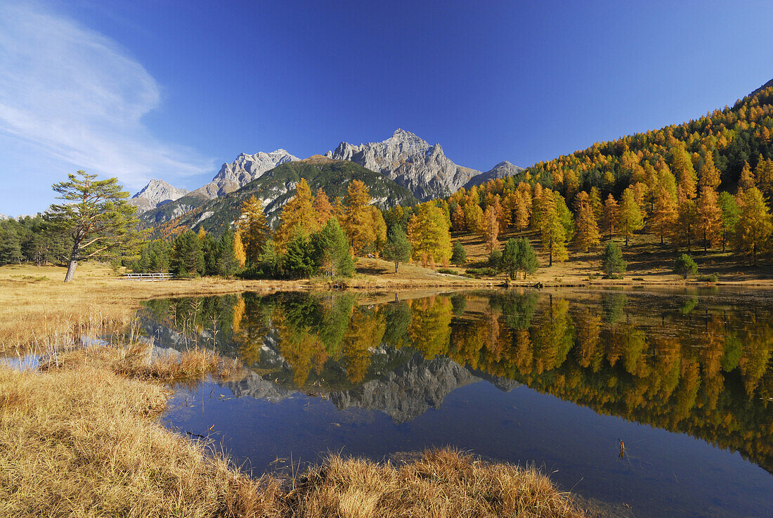 View over a lake to Piz Lischana and Piz San Jon, Lower Engadin, Engadin, Grisons, Switzerland