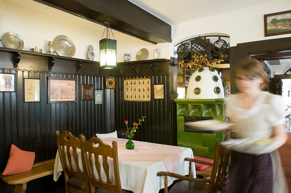 A waitress at dining area of Hotel and Restaurant Löwen, Marktbreit, Franconia, Bavaria, Germany